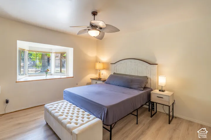 Bedroom with light wood-style flooring and ceiling fan