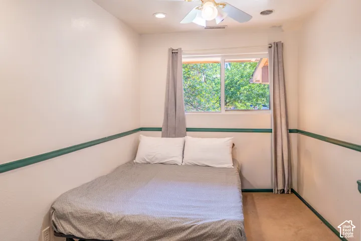 Bedroom featuring carpet flooring and a ceiling fan