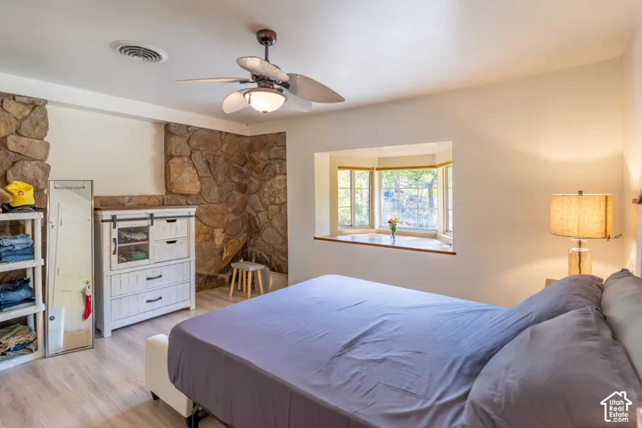 Bedroom with wood finished floors and a ceiling fan
