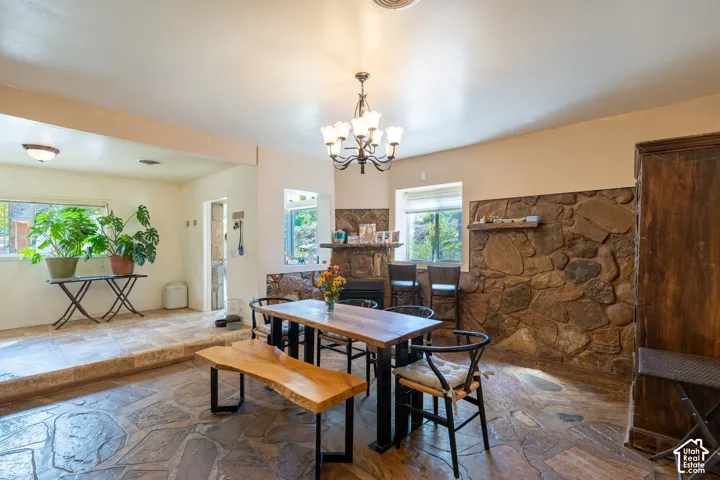 Dining area featuring stone floors and a chandelier