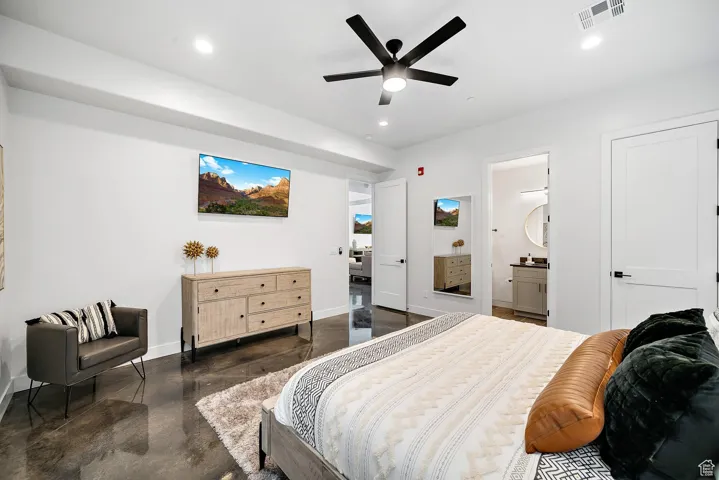 Bedroom featuring finished concrete floors, recessed lighting, a ceiling fan, and connected bathroom