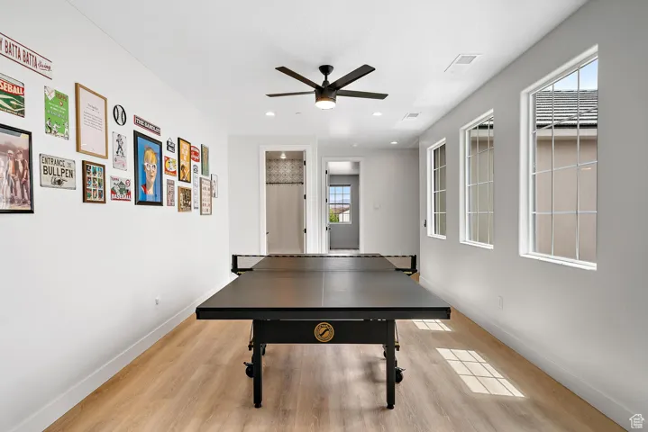 Rec room featuring light wood-type flooring, ceiling fan, and recessed lighting