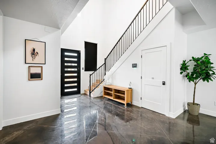 Foyer featuring a high ceiling and stairs