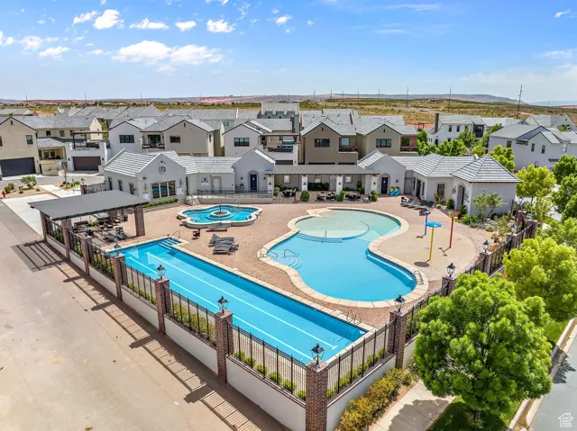 Community pool with a residential view and a patio area