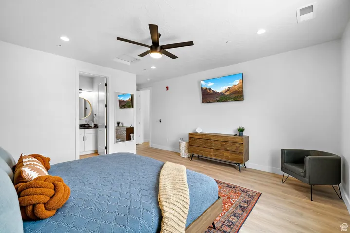 Bedroom with light wood-style floors, a ceiling fan, recessed lighting, and attic access