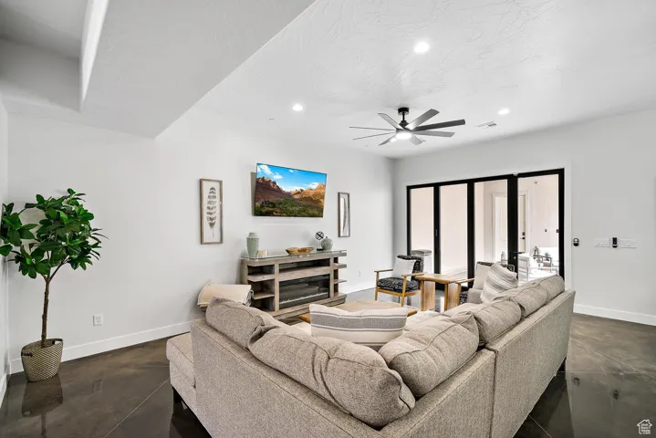 Living area featuring recessed lighting, concrete floors, a ceiling fan, and a textured ceiling