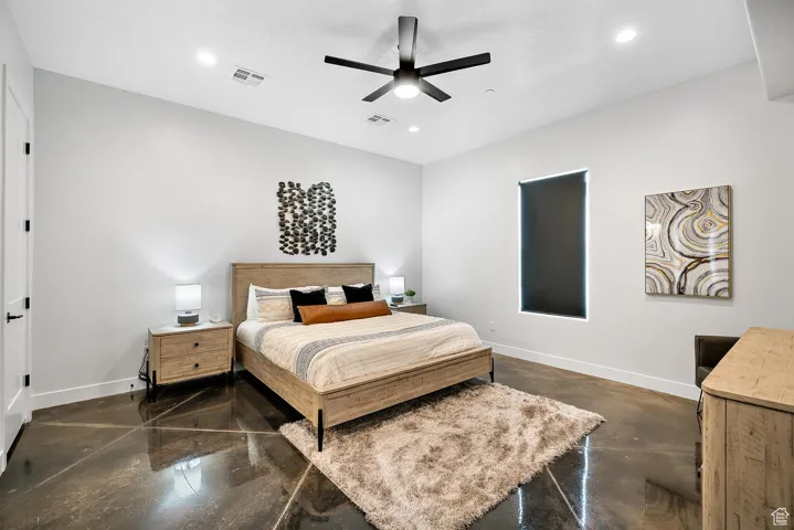 Bedroom with concrete floors, recessed lighting, and a ceiling fan
