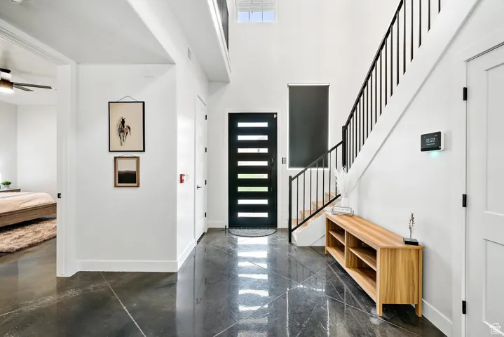 Foyer with a towering ceiling and stairs