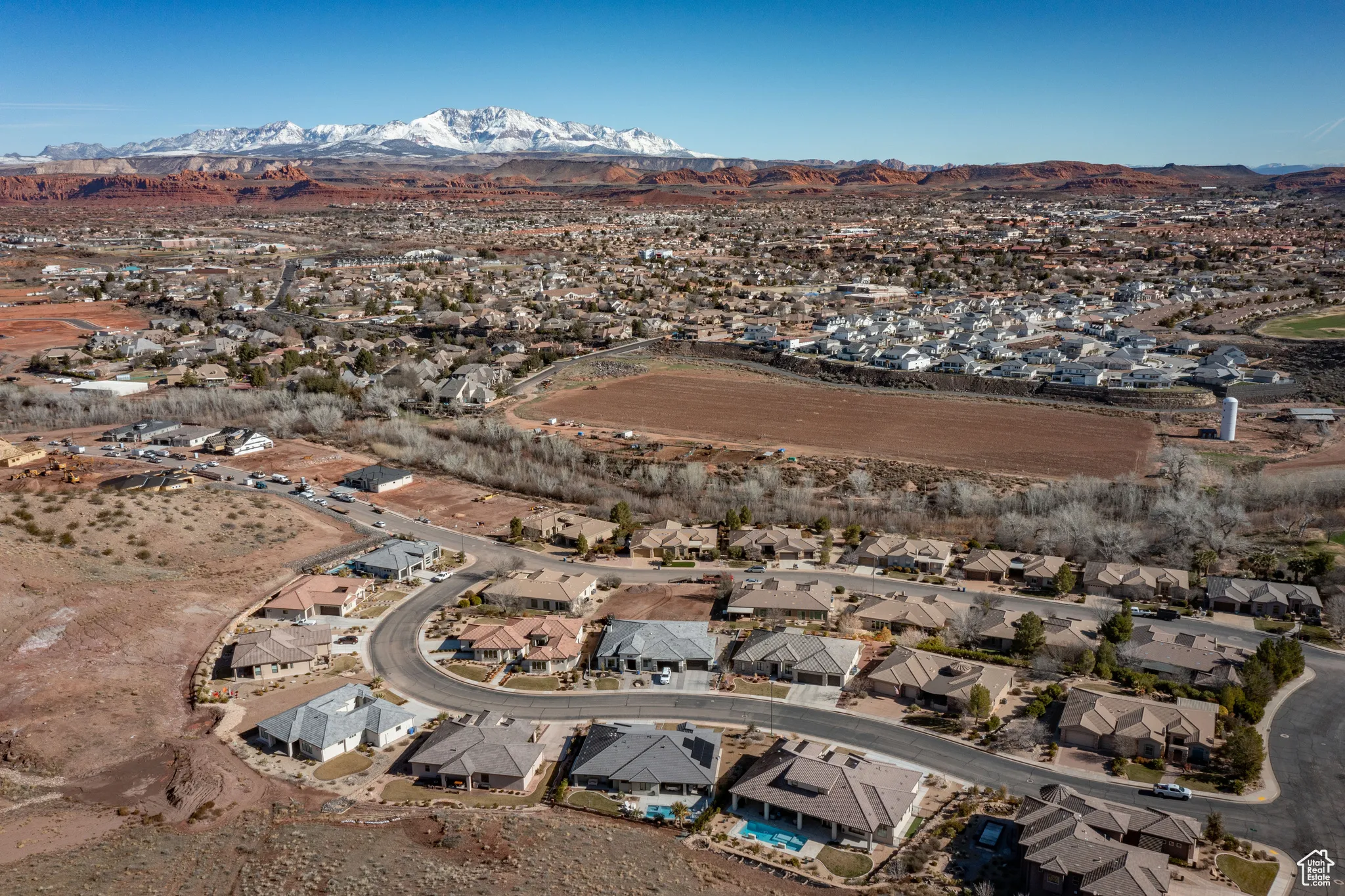 Aerial view of property's location featuring a mountainous background and nearby suburban area