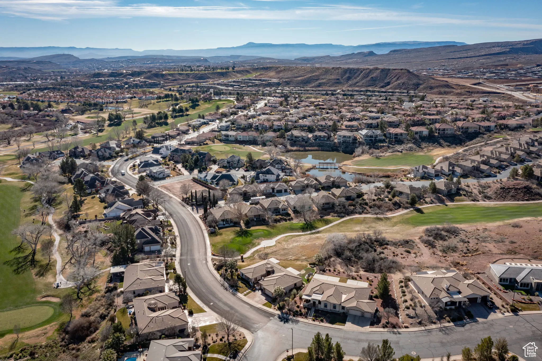 Aerial overview of property's location with nearby suburban area and a water and mountain view