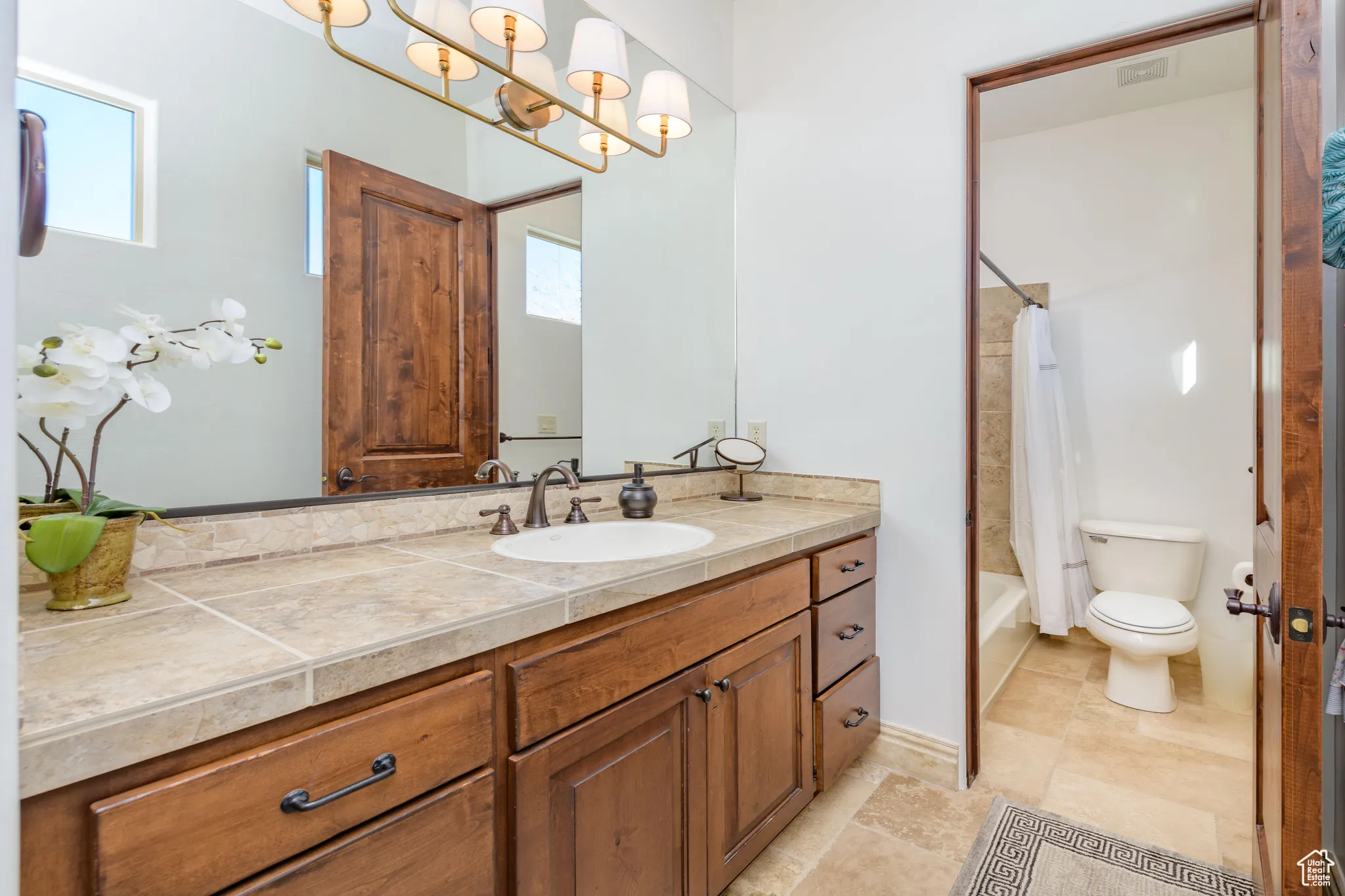 Bathroom with vanity and shower / bath combo