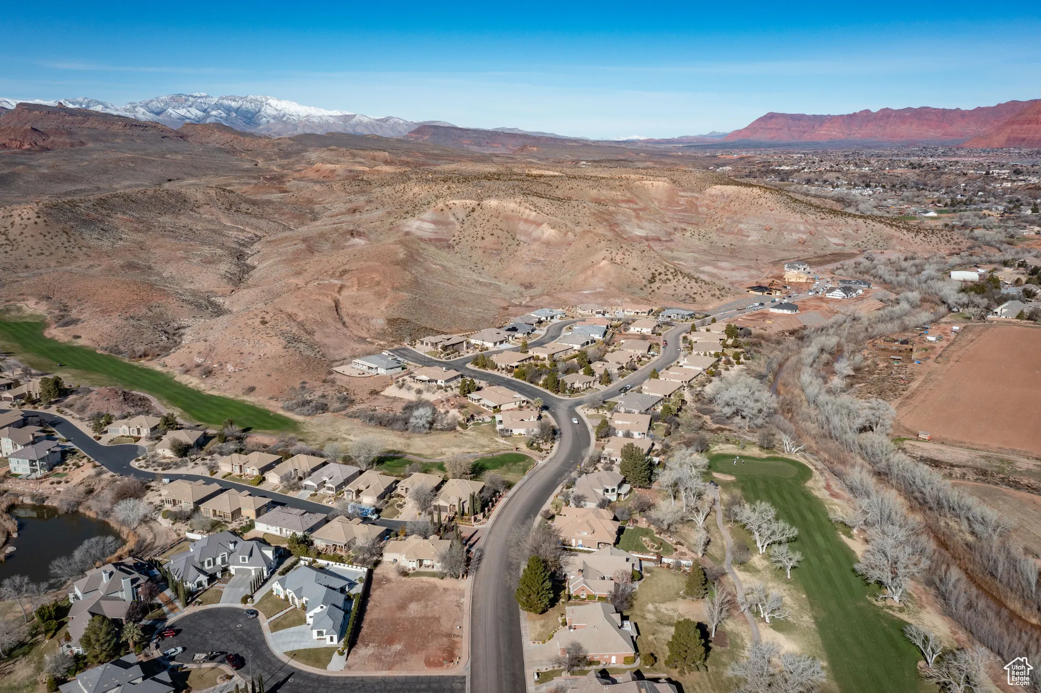 Aerial overview of property's location featuring mountains and nearby suburban area