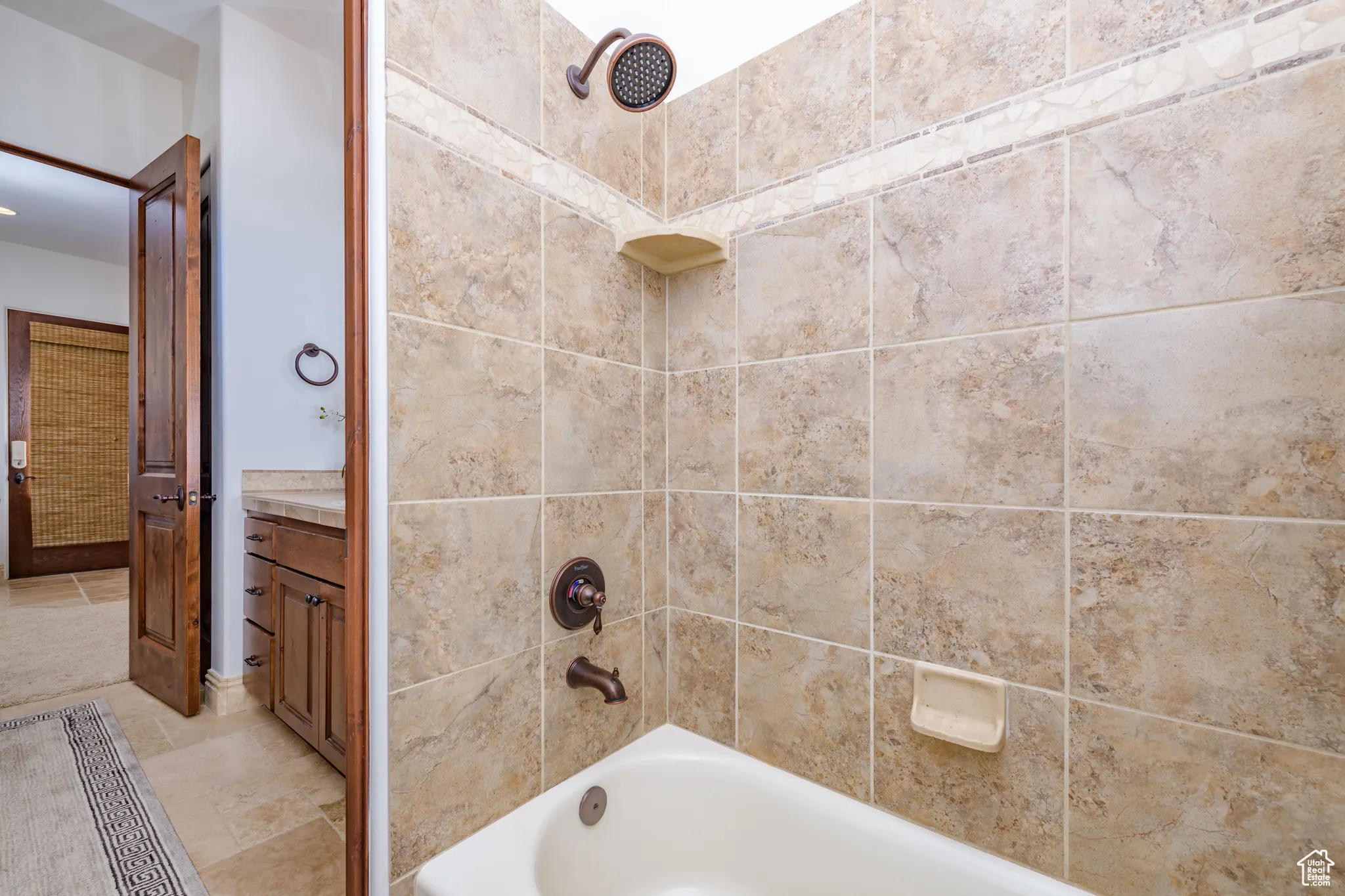 Full bath featuring vanity and shower / washtub combination