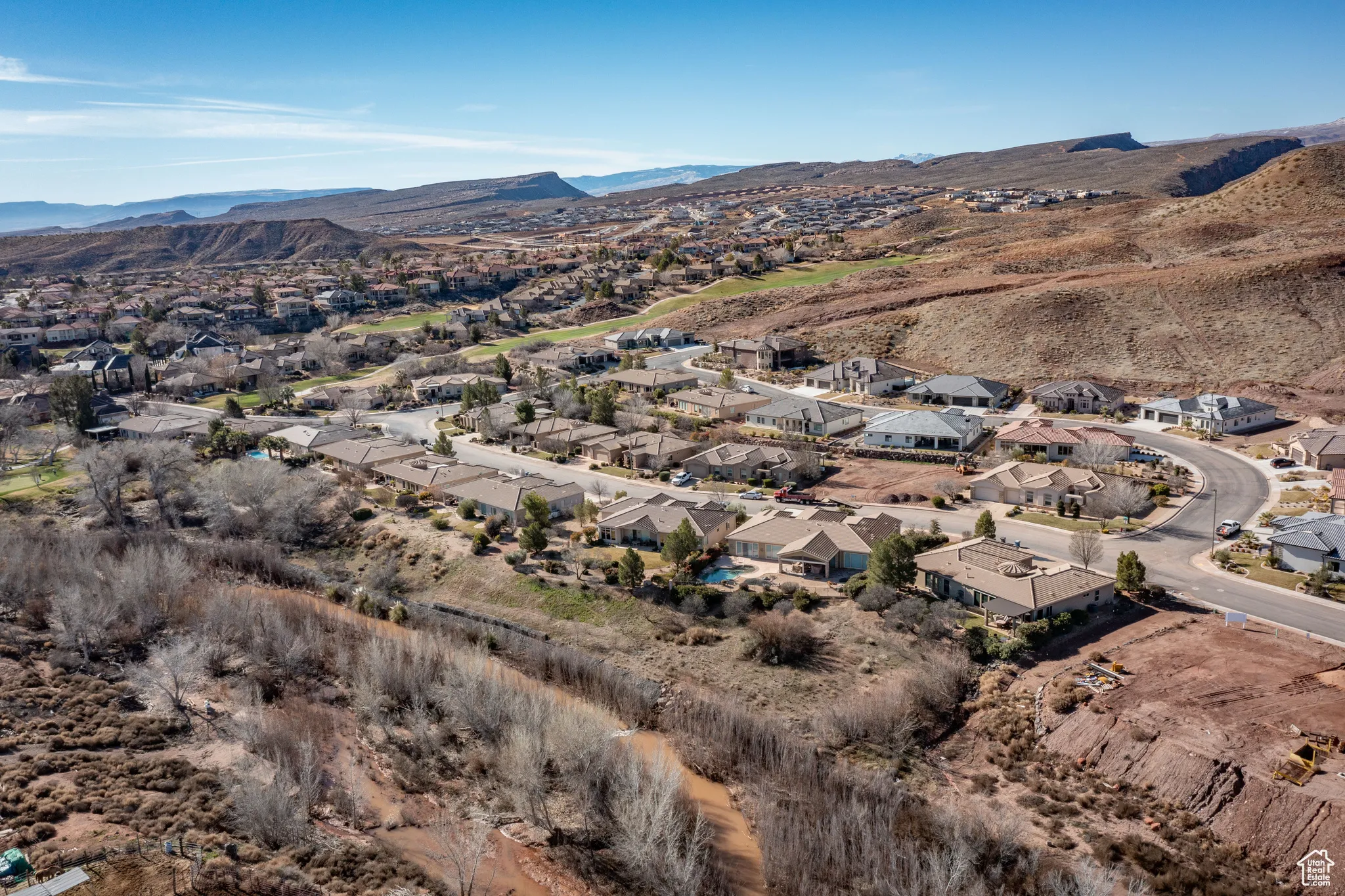 Aerial view of property's location with nearby suburban area and mountains