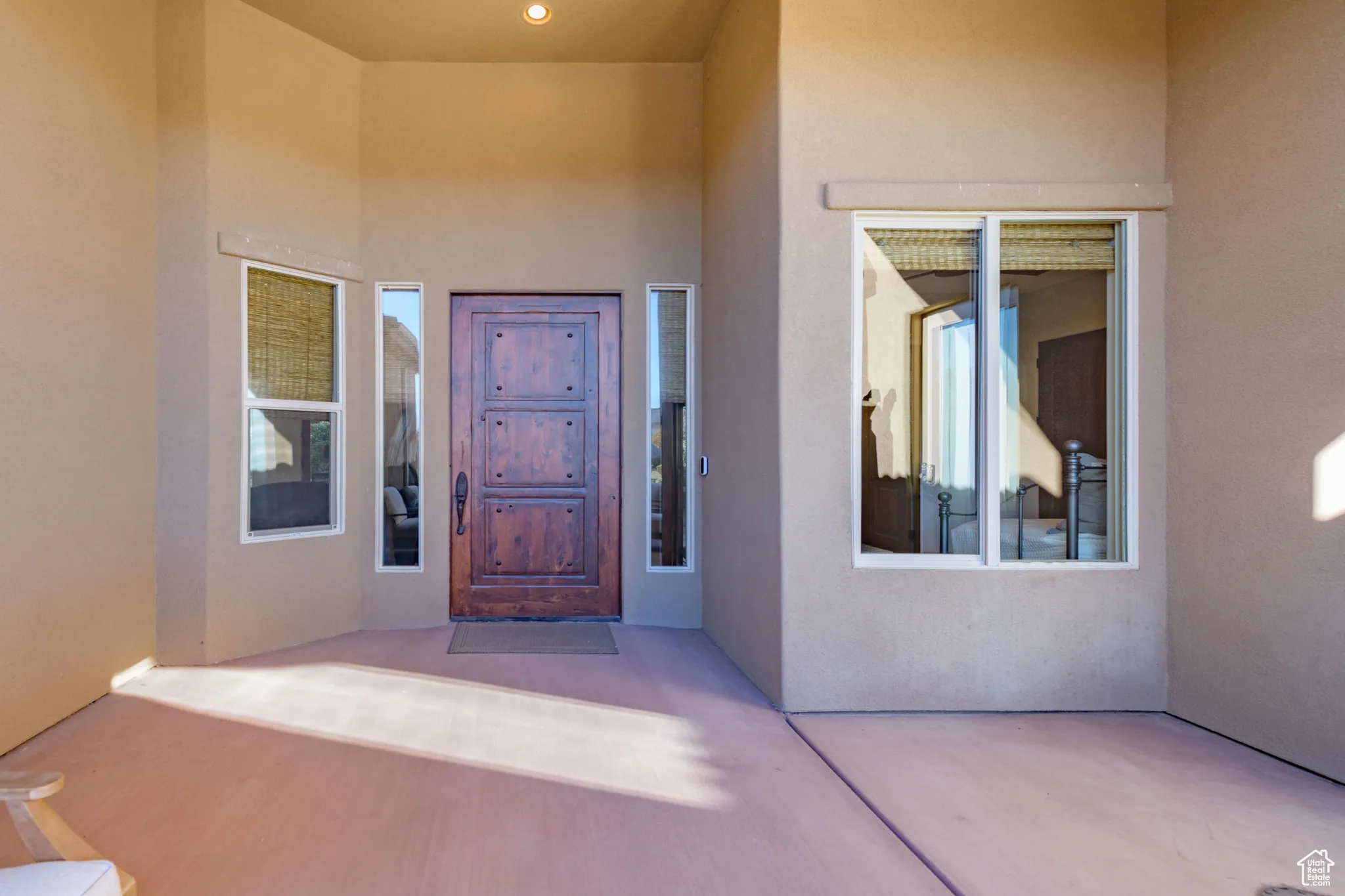 Entrance to property featuring a patio area and stucco siding