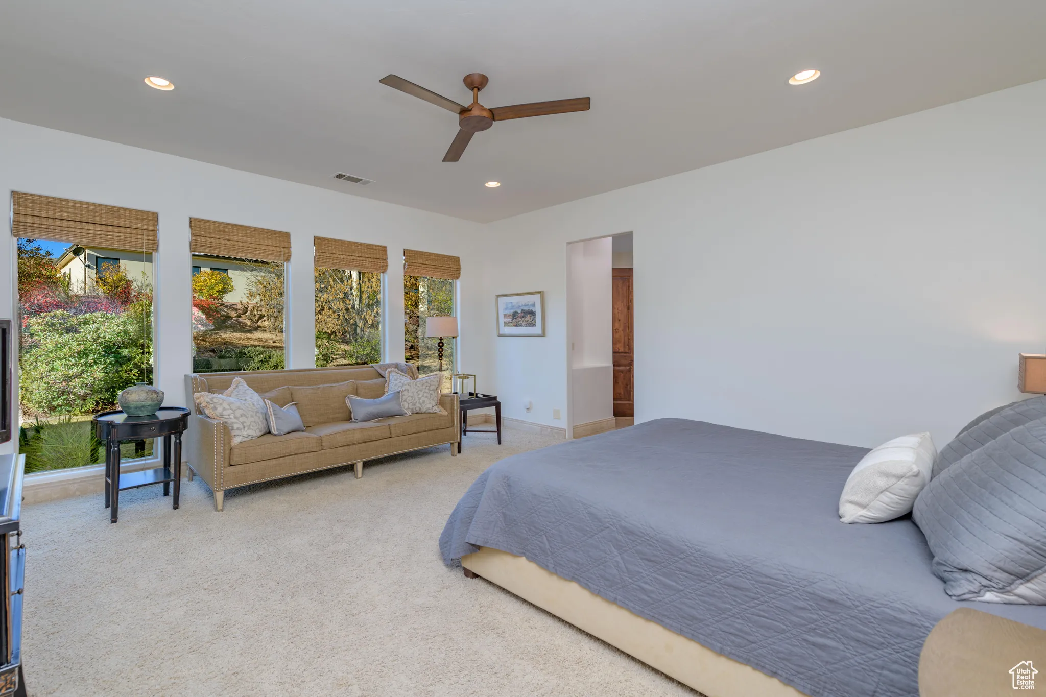 Carpeted bedroom featuring recessed lighting and a ceiling fan