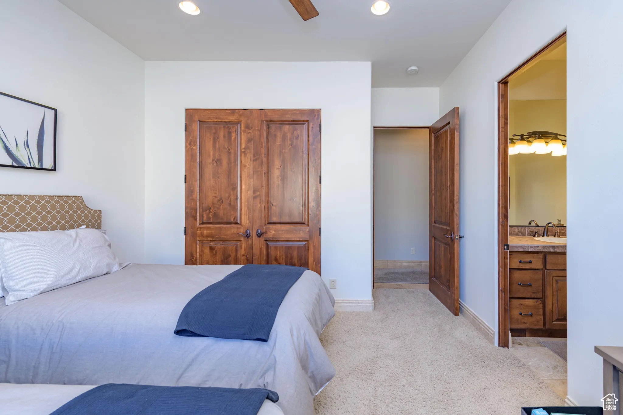 Bedroom with recessed lighting, light colored carpet, a closet, a ceiling fan, and connected bathroom