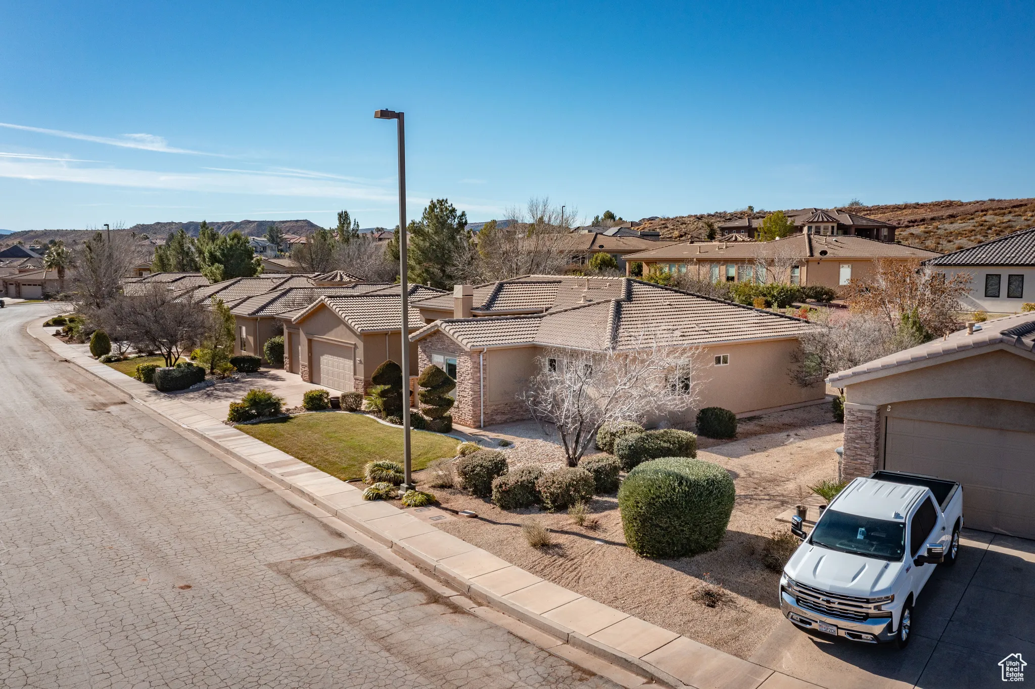 View of front of home with a residential view, a garage, and stucco siding