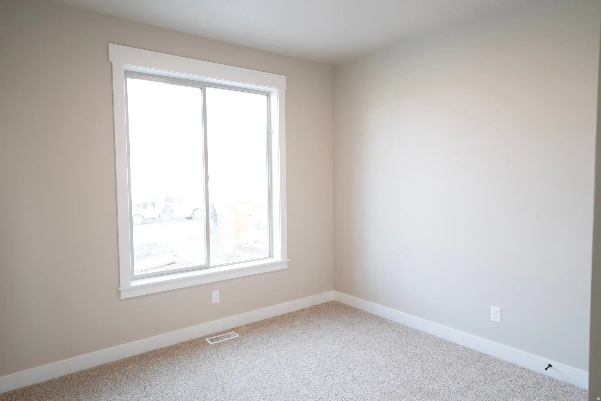 Unfurnished room with baseboards and carpet