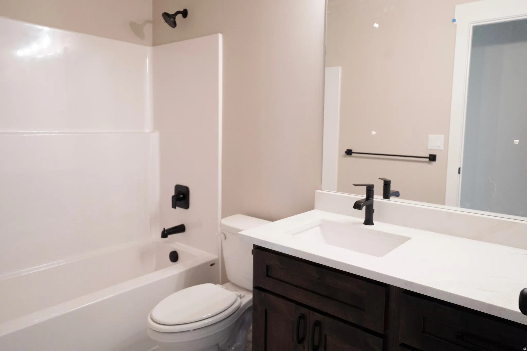 Full bath featuring vanity and shower / tub combination