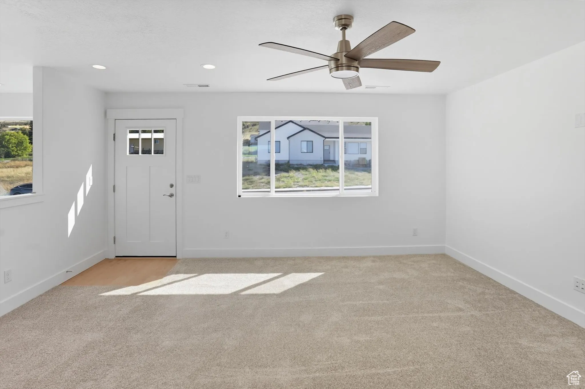 Entryway featuring light carpet, recessed lighting, and ceiling fan