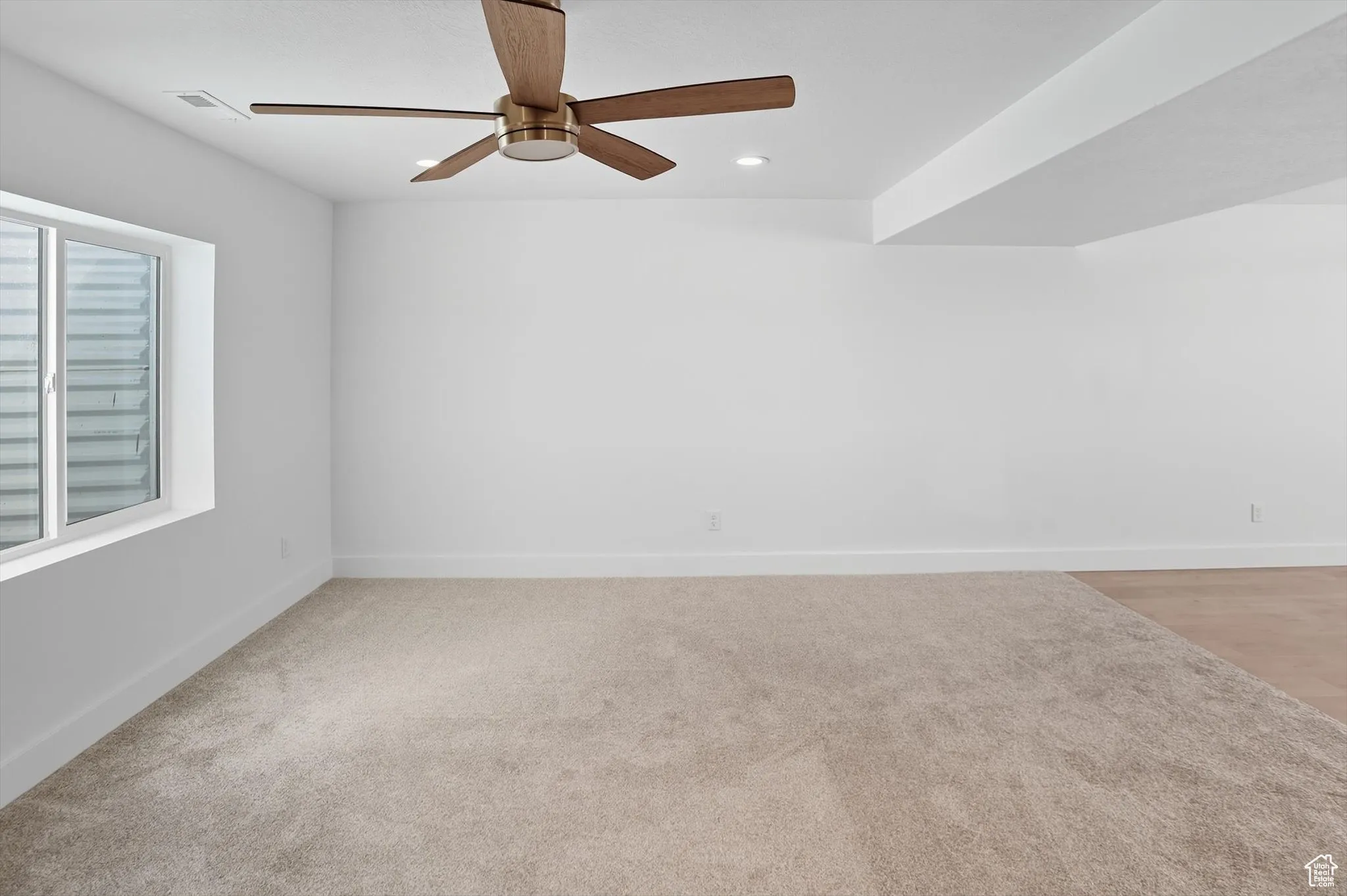 Unfurnished room with recessed lighting, a ceiling fan, and light colored carpet