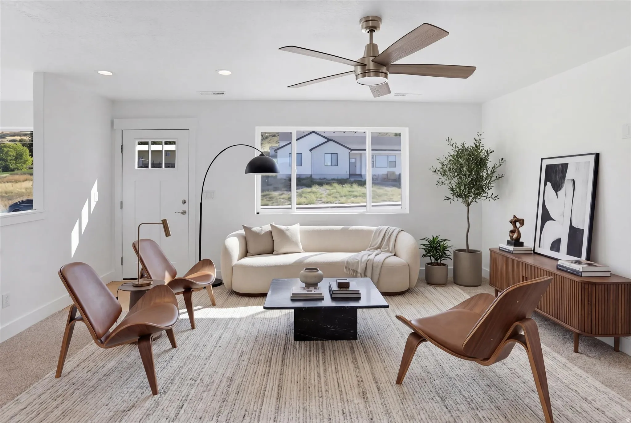 Living room featuring a ceiling fan and recessed lighting