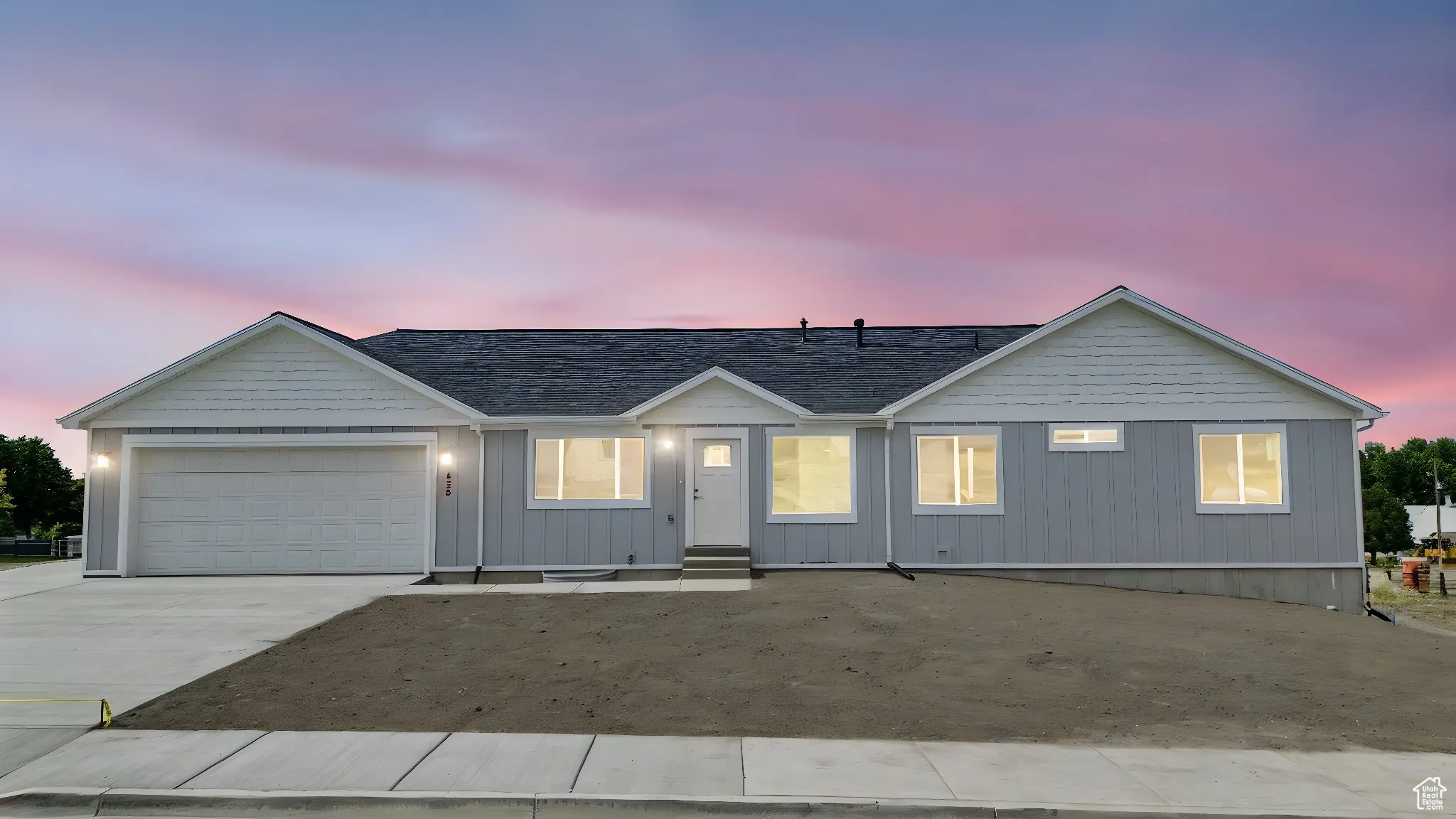 Ranch-style house featuring driveway, a garage, and board and batten siding