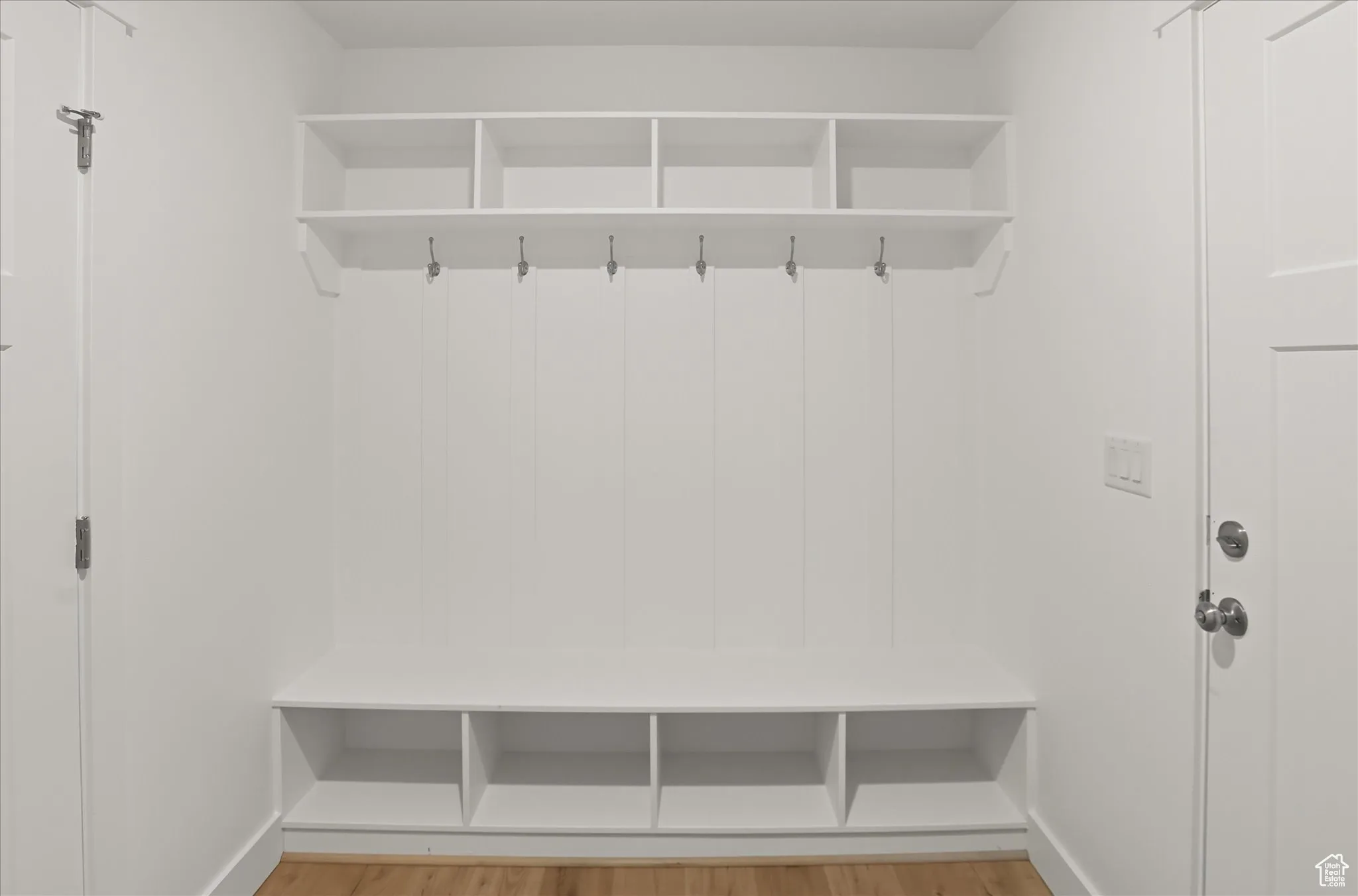 Mudroom with light wood-style flooring and baseboards