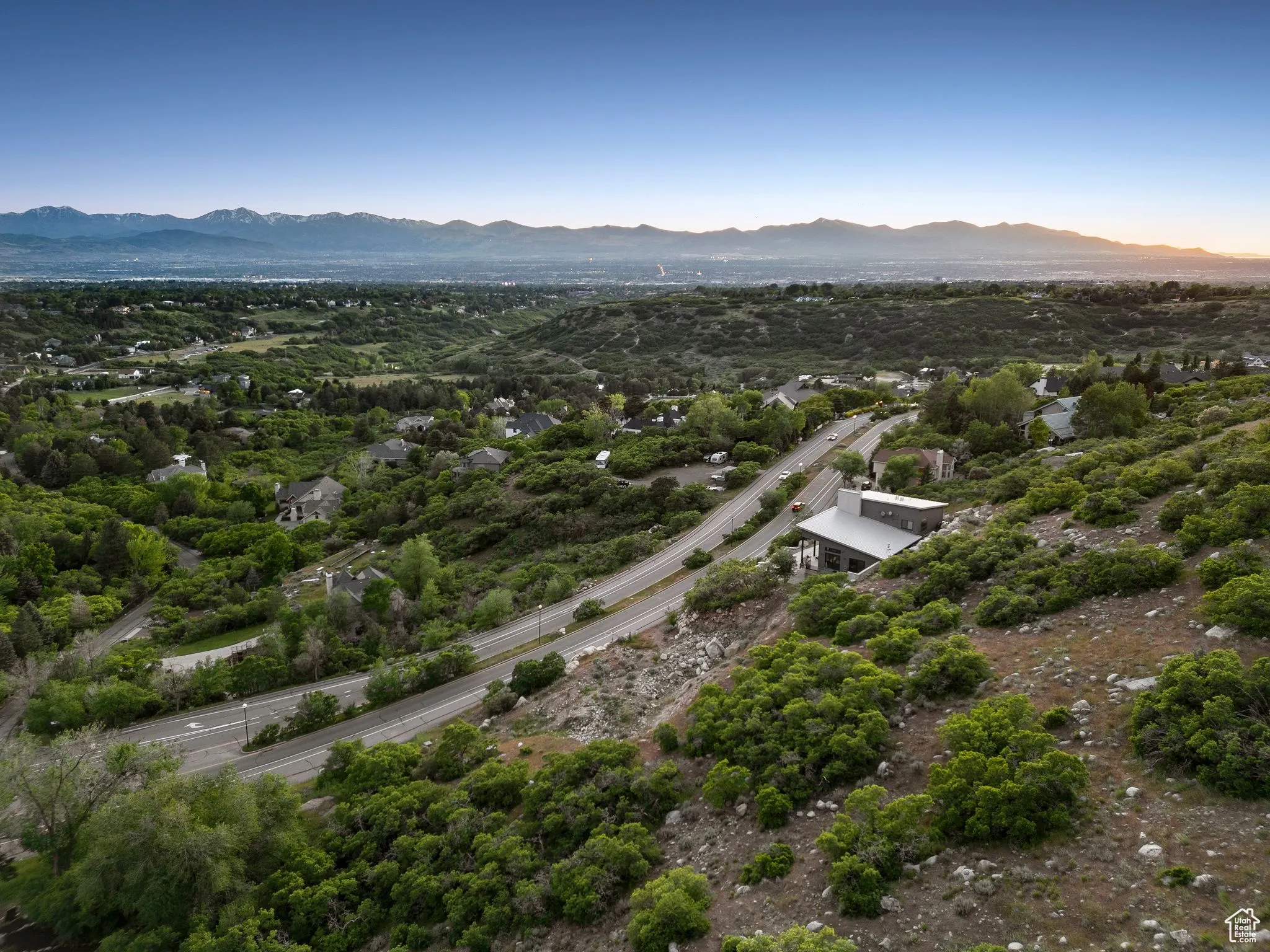 Drone / aerial view of mountains and a tree filled landscape