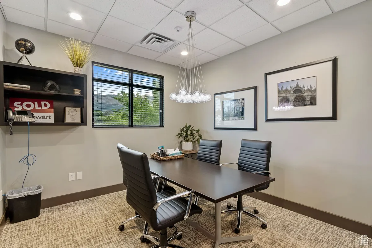 Office with a drop ceiling and recessed lighting