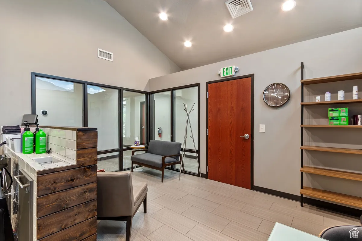 Interior space with recessed lighting and high vaulted ceiling