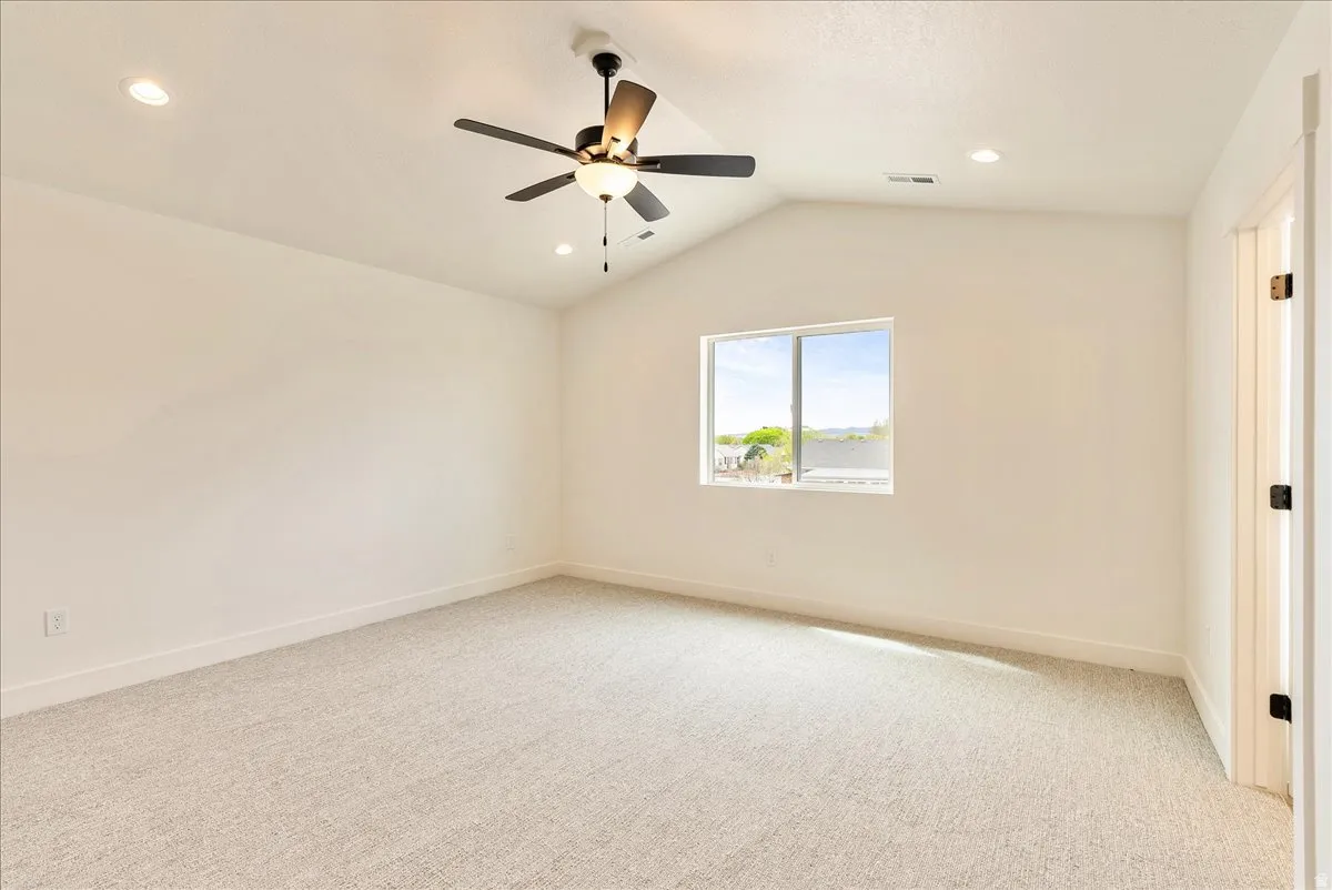 Unfurnished room with light colored carpet, ceiling fan, and recessed lighting