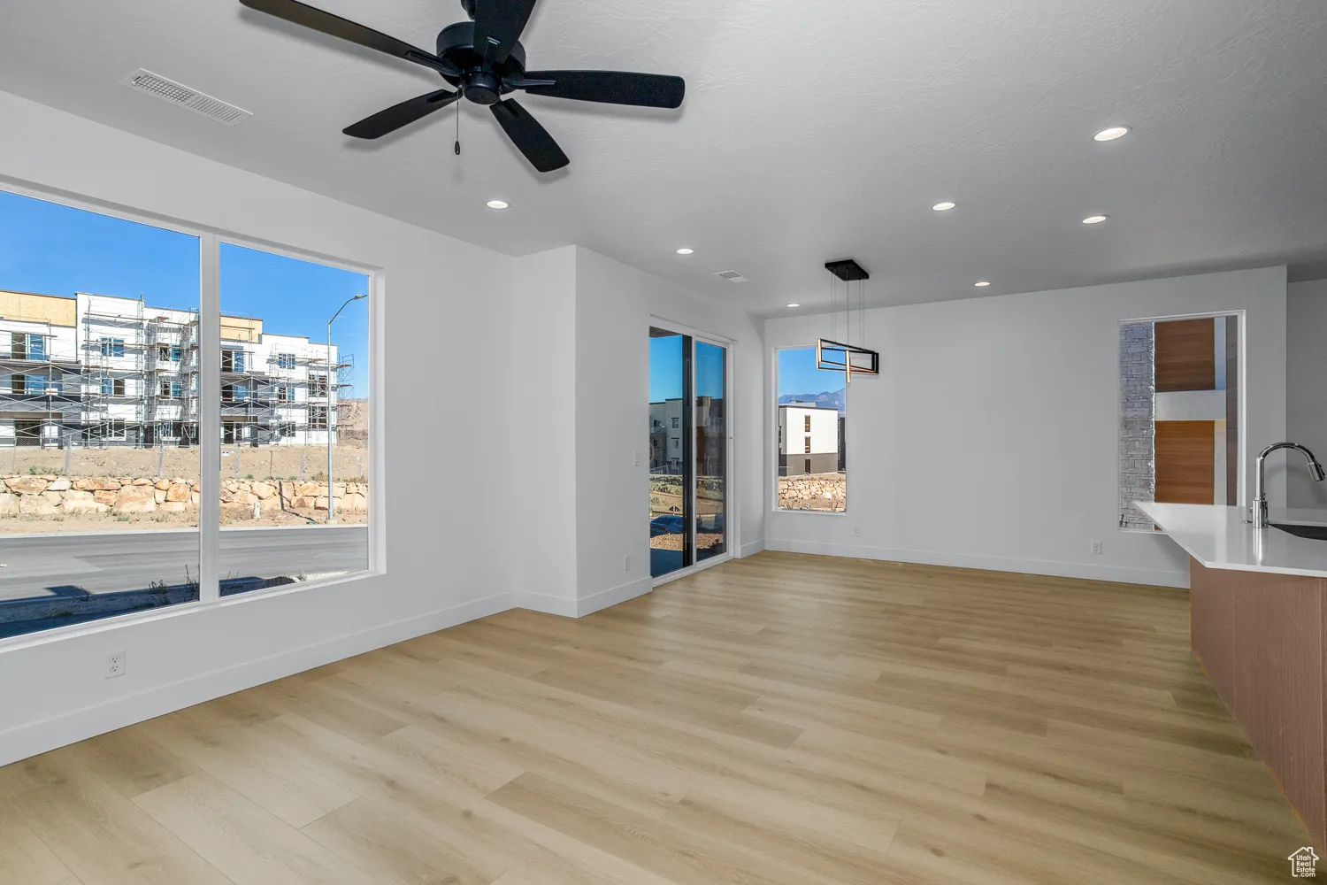 Unfurnished living room featuring light wood finished floors, recessed lighting, and ceiling fan