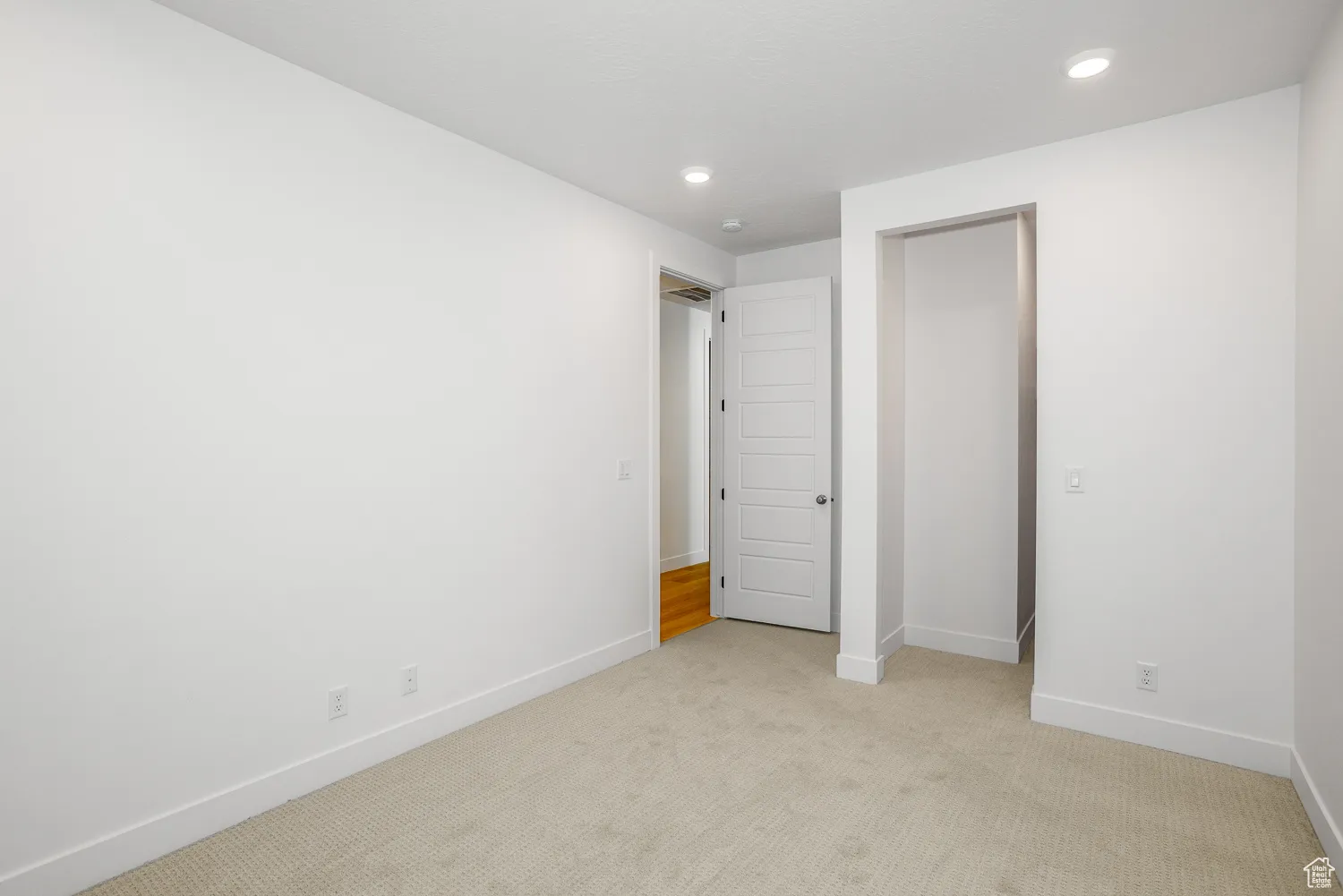 Unfurnished bedroom featuring light colored carpet and recessed lighting
