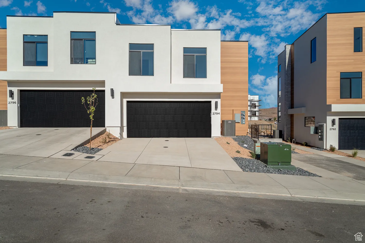 Modern home with stucco siding, concrete driveway, and an attached garage