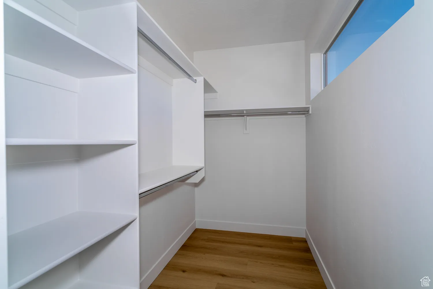 Spacious closet with light wood-style floors