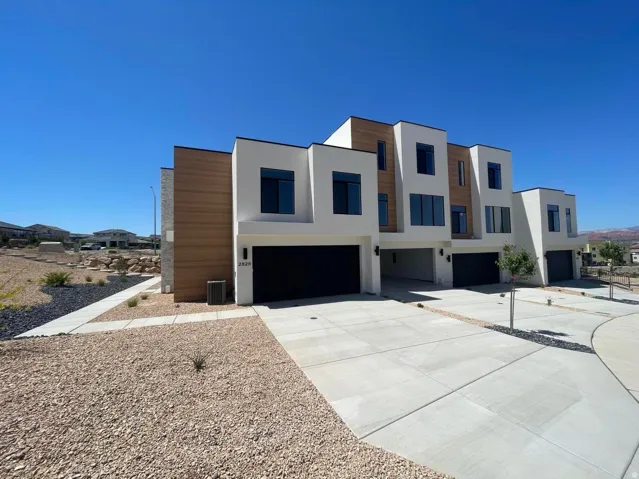 Contemporary exterior with white stucco and wood-finish siding accents
