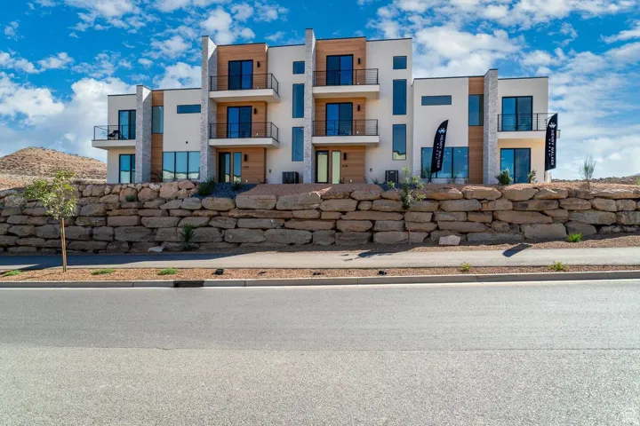 Modern architectural style with white stucco and wood-finish paneling