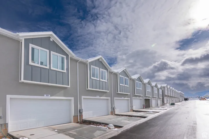 Rear view featuring 2-car garage