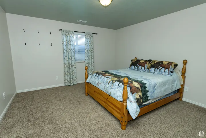 Carpeted bedroom featuring baseboards