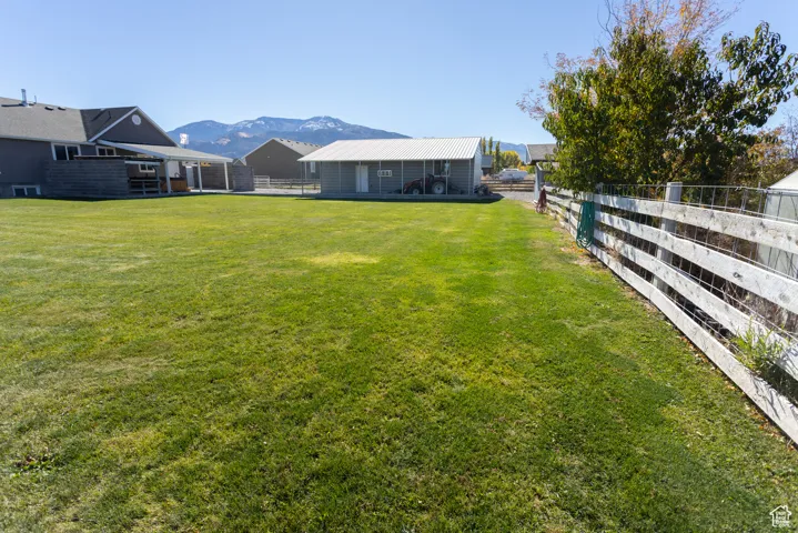 Fenced backyard with a mountain view and a patio