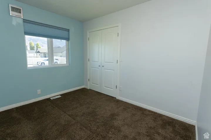 Unfurnished bedroom featuring carpet floors and a closet