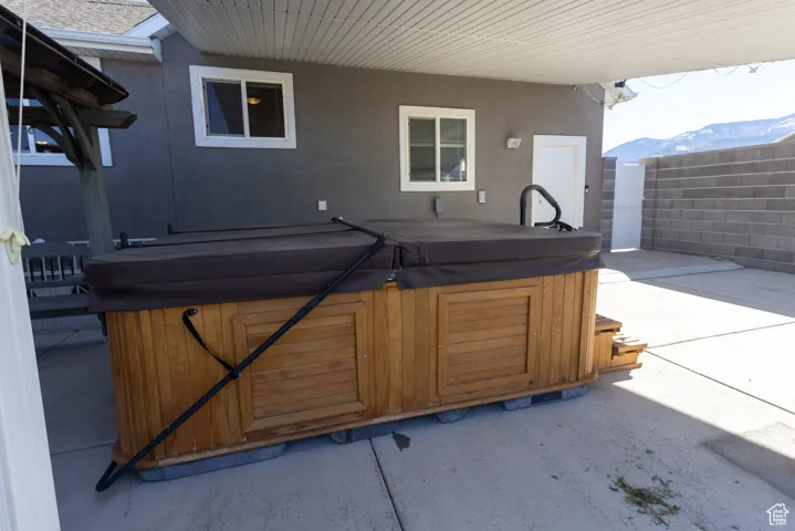 View of patio / terrace featuring a mountain view and a hot tub