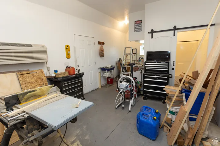 Garage featuring a wall mounted air conditioner
