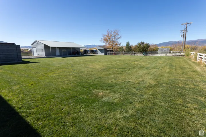 View of yard with a mountain view and a view of rural / pastoral area