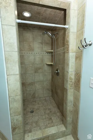 Full bath featuring a shower stall