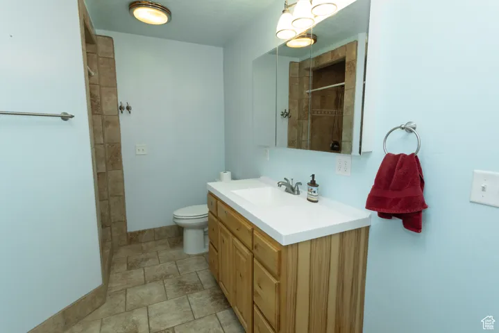 Bathroom with vanity and a tile shower