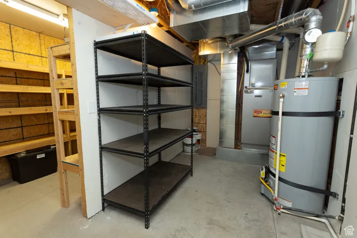 Unfinished basement with secured water heater, electric panel, and heating unit