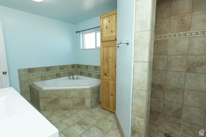 Bathroom with vanity and a bath